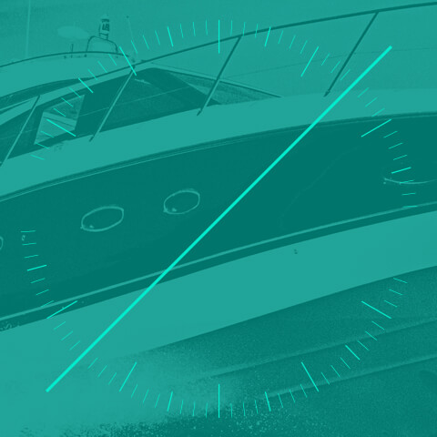 Blue-green tinted image of small yacht with dial and diagonal line on top