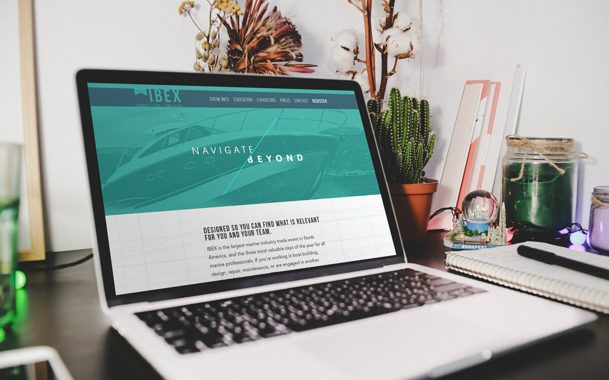 Mockup of laptop on desk with IBEX homepage