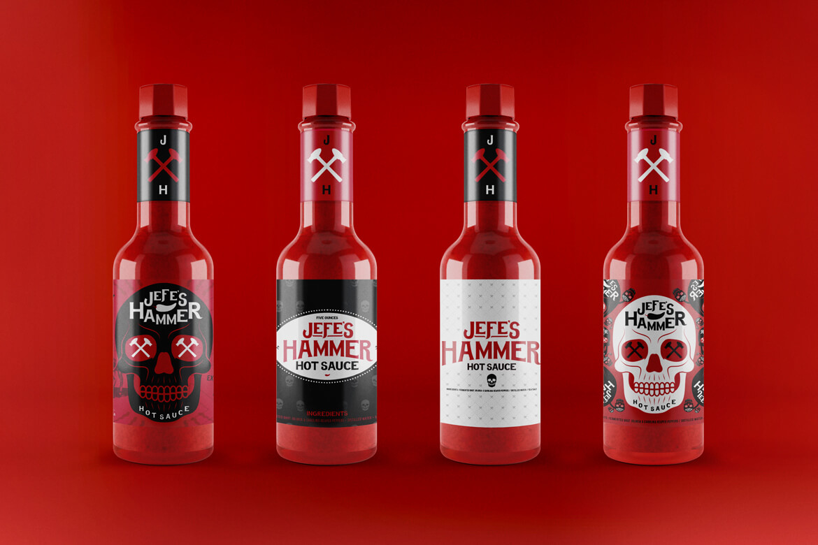 Photo of four bottles with different labels lined up next to each other on red background