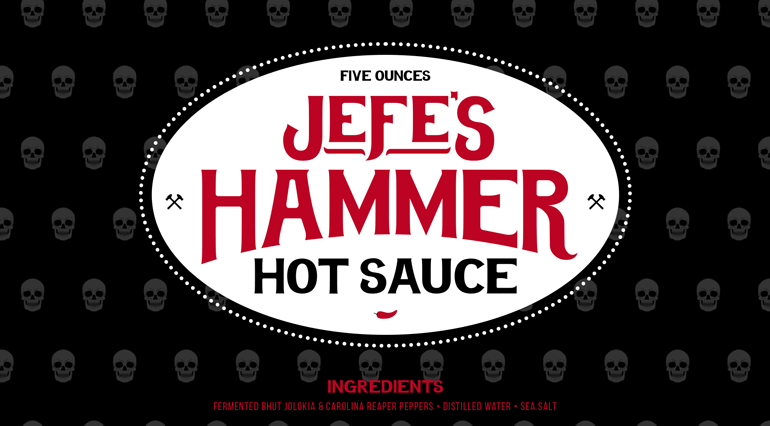 Sauce bottle black label with bespoke hammer pattern in background and large red logo text sitting inside white circle in center
