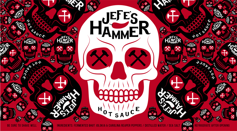 Sauce bottle red label with white skull design in the middle and smaller versions/orientations of the skulls in black on either side
