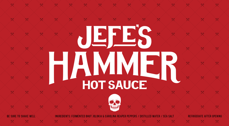 Sauce bottle red label with bespoke hammer pattern in background and large white logo text in center